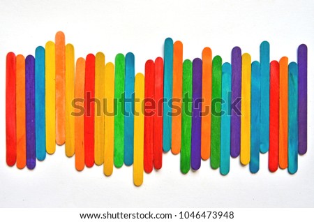 Beautiful fresh and bright colored wooden sticks on white floor