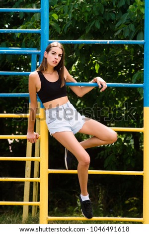 Fashion model will warm in the summer in a photo shoot. dressed in short shorts of jinn. Portrait