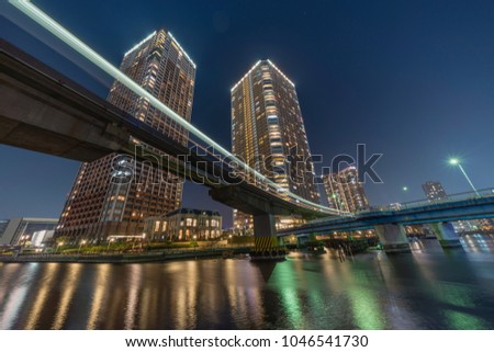 Tokyo bay area high rise apartments as a monorail train passes by