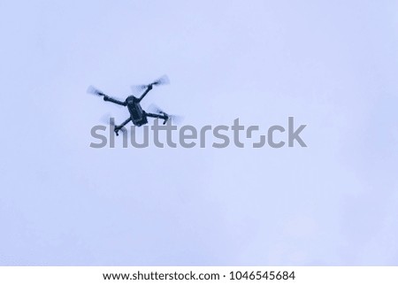 flying drone against blue sky