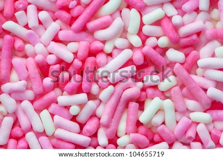 Pink and white sugar sprinkles for confectionery. High magnification macro.