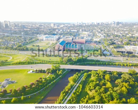 Aerial view Fourth Ward district west of downtown Houston, Texas, USA. Allen Parkway and  Buffalo Bayou River in front with midtown skyline buildings are in the distance.