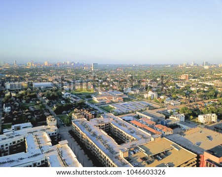 Aerial view Fourth Ward district west of downtown Houston, Texas, USA. Residential neighborhood, office buildings, restaurants, parking lots, church and midtown skyline are in the distance.