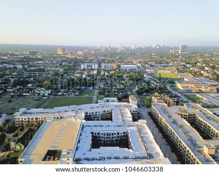 Aerial view Fourth Ward district west of downtown Houston, Texas, USA. Residential neighborhood, office buildings, restaurants, parking lots, church and midtown skyline are in the distance.
