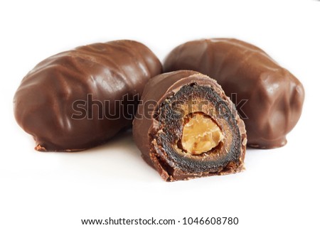 Chocolate covered dates stuffed with almonds isolated on white background Royalty-Free Stock Photo #1046608780