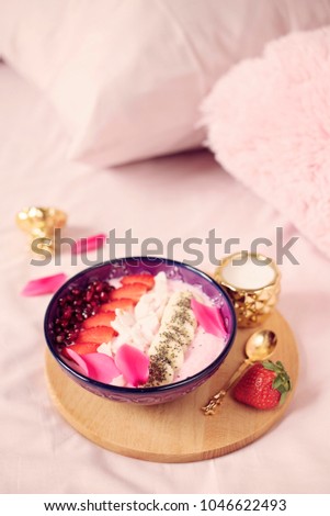 Smoothie bowl with fresh berries, seeds and fruits. Healthy breakfast in the bed.