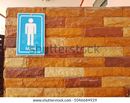 Man toilet sign on the granite wall