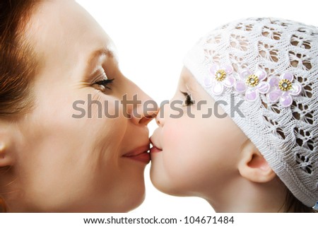 Mother kissing her daughter on a white background