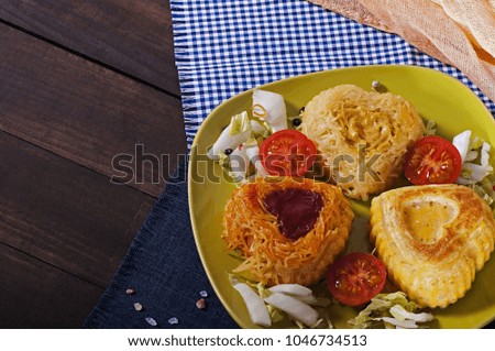 Three kinds of Italian pasta on a green plate. With tomato sauce. With mustard sauce. Baked with egg in the oven.