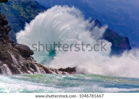Spectacular ocean wave breaking on the shoreline on the island of Kauai, Hawaii.