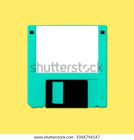 Obsolete 3.5 inch computer diskette, isolated and presented in punchy pastel colors with a blank white customizable label. Theme of early digital storage media for factual work and creative design