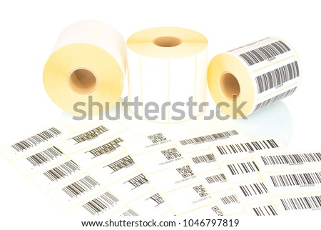 White label rolls and printed barcodes isolated on white background with shadow reflection. White reels of labels for printers. Labels for direct thermal or thermal transfer printing. Barcode samples. Royalty-Free Stock Photo #1046797819