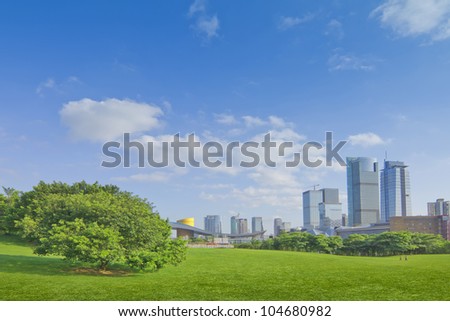 City park under blue sky with Downtown Skyline in the Background