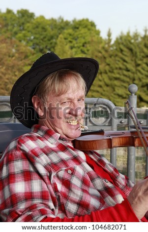 old man is playing violin on his balcony