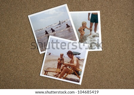 Old photo album photographs from the early 1970's of family at a beach on a bulletin board.