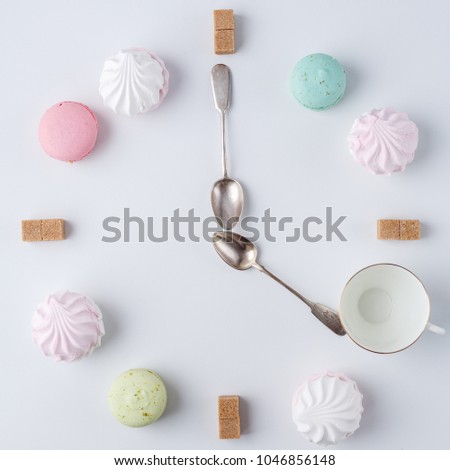 A clock in the form of coffee. macarons, sugar, marshmallows. creative and creative work. time to drink coffee