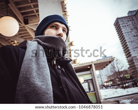 portrait of man in the europe city in the street on a winter day