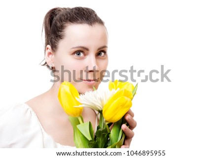 Portrait of beautiful young attractive brunette woman with spring bouquet of yellow and white flowers tulips isolated on white background.