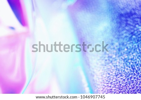 Colorful blurred holographic background in ultraviolet neon trendy colors. Holographic neon glitch wallpaper.