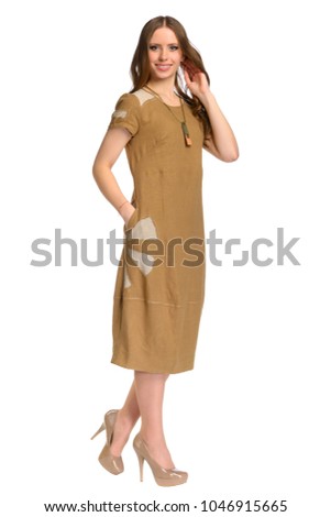 Textiles, design, clothing, fashion concept. Fashionable girl in clothes made of flax, isolated on white background