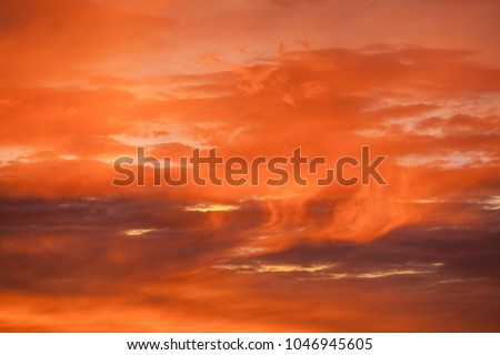 Storm clouds at sunset with an orange glow. 