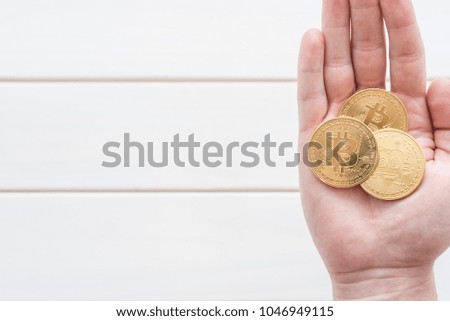 gold coin bitcoin in hand