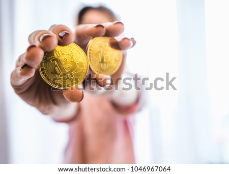 The girl holds a bitcoin gold coin, the girl is in high definition