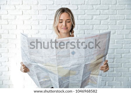 Blonde woman looks at a map