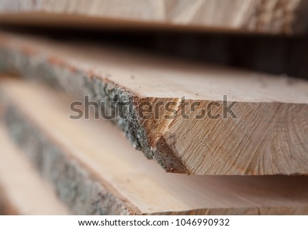 Folded wooden planks in a sawmill. Piled boards as texture Royalty-Free Stock Photo #1046990932