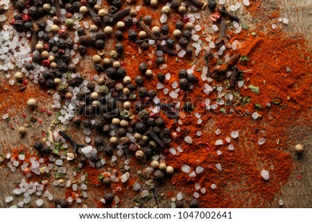 Black and white pepper peas, sea salt, red pepper powder, cloves, spices on a wooden background. Various colorful spices closeup background. photo for the menu. photo for the cookbook. Selective focus