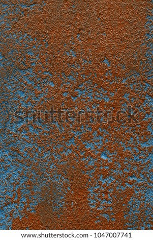 Red blue background from a fragment of a concrete wall of a building