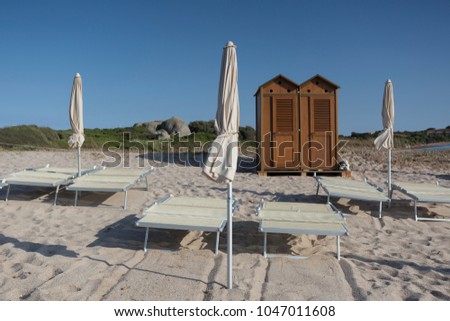 Empty Sandy Beach with Umbrellas and bathing-hut