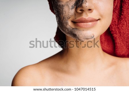 young cute girl looks after the skin, has put on a useful mask, day spa