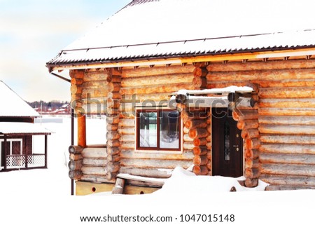 Background image, Construction of a wooden house. Country house on a background of white snow. Can be used as a background or ad decoration wich copy space. 