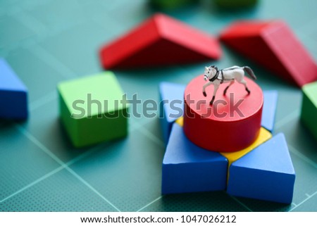 Miniature people : children with wooden block and mini toy horse, Education concept.