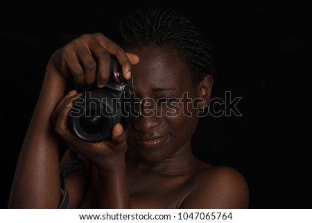 girl standing on a black background doing a photo.