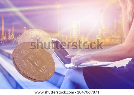 golden bitcoin Cryptocurrency on computer circuit board closeup shot on refinery industrial background