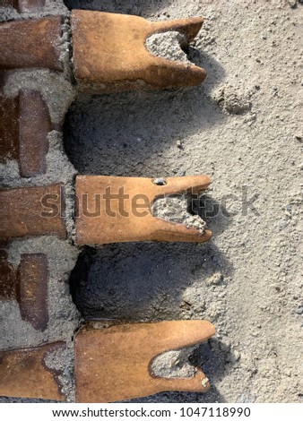 Closeup of excavator digging teeth on construction site