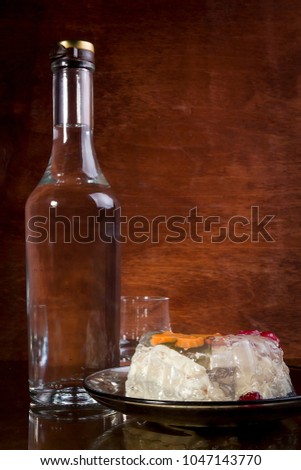 Bottle of vodka on a brown wooden background