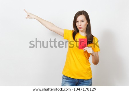 European serious severe young woman, football referee in yellow uniform show red soccer card, propose player retire from field isolated on white background. Sport, play, healthy lifestyle concept
