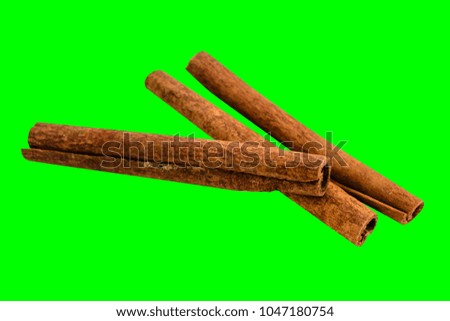 Cinnamon sticks isolated on green background. Food photo.
