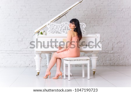 Women hispanic appearance with white piano at bright light room. Concept of human and classic music
