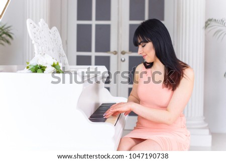 Women hispanic appearance with white piano at bright light room. Concept of human and classic music