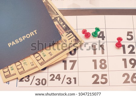 Dollars in blue passport against the backdrop of calendar numbers, days of the week, close-ups