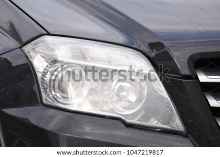 shiny headlights on a new black car
