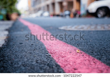 Red line on the road.Street.Traffic instruction.Low angle.Vintage tone. Royalty-Free Stock Photo #1047222547