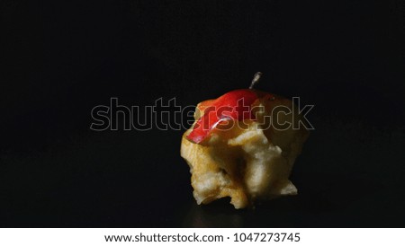 Bitten red apple isolated with black background