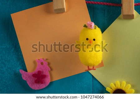 Easter colored cards hanging on a blue wooden background