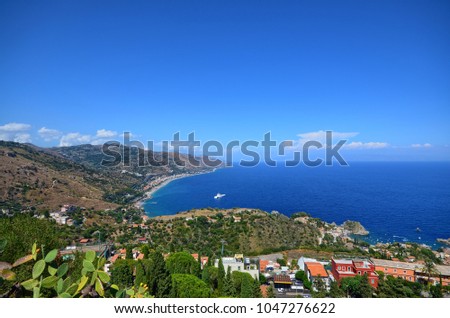 Taormina, Italy, Sicily August 26 2015. The splendid panorama from the Greek theater, towards the sea. Lush nature, Mediterranean vegetation, flowers. Sea and boats.