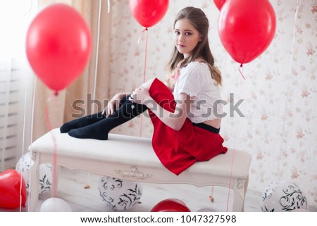 Girl with balloon party in red room studio